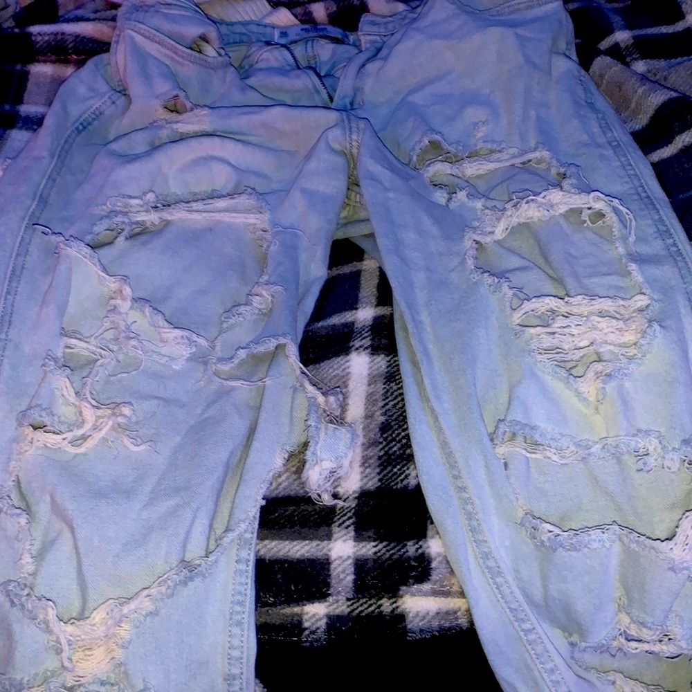 Ripped jeans with a 2 rips in the back and many in the front. Cute and trendy